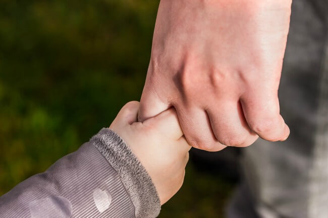 Parent holding hands with child